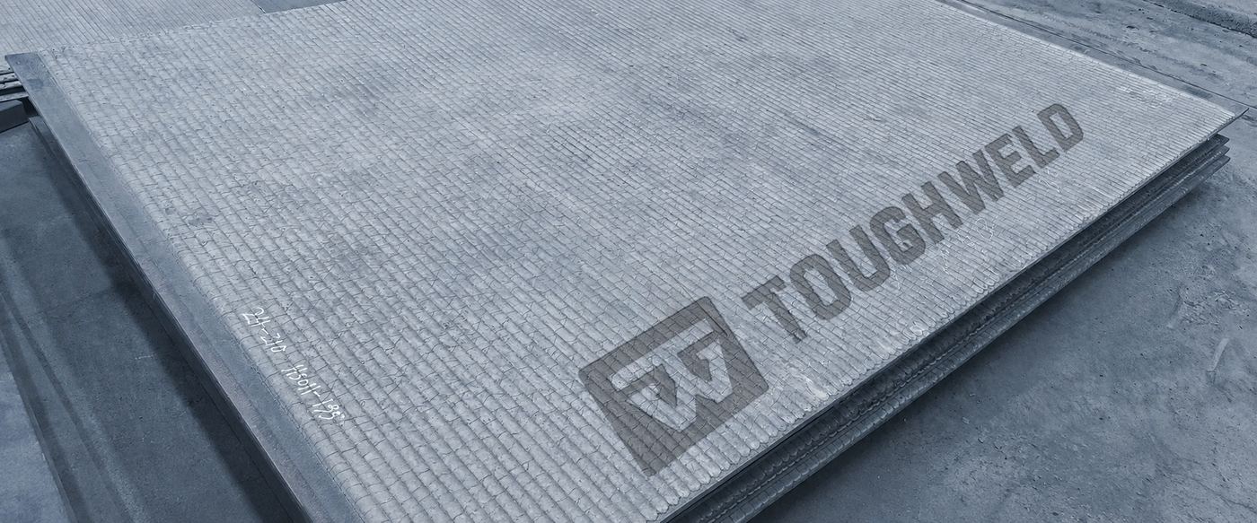 Stacked overlay wear plates with a ridged surface and Tough Weld branding